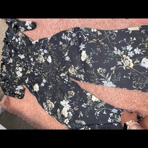 Light black romper with floral pattern.